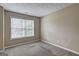 This bedroom features neutral paint and carpet, with a window providing natural light at 2093 Parador Bnd, Mcdonough, GA 30253