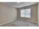 This bedroom features neutral paint and carpet, with a window providing natural light at 2093 Parador Bnd, Mcdonough, GA 30253