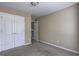 Bedroom featuring neutral paint, carpet, ceiling light, double door closet and doorway to hallway at 2093 Parador Bnd, Mcdonough, GA 30253