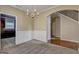 Dining room with wainscoting, an elegant chandelier, leading to kitchen and stairway at 2093 Parador Bnd, Mcdonough, GA 30253