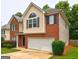 Attractive two-story home with brick and beige siding and a two car garage, lush landscaping at 2093 Parador Bnd, Mcdonough, GA 30253