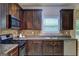 This kitchen features dark wood cabinets, granite countertops, and stainless steel appliances at 2093 Parador Bnd, Mcdonough, GA 30253