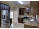 The kitchen is fully equipped with stainless steel appliances and dark wood cabinets at 2093 Parador Bnd, Mcdonough, GA 30253