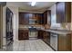 Well-equipped kitchen with stainless steel appliances, dark wood cabinets, and tile backsplash at 2093 Parador Bnd, Mcdonough, GA 30253