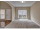 Neutral living room with carpet, natural light, and access to front door at 2093 Parador Bnd, Mcdonough, GA 30253