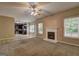 Spacious living room with fireplace and access to an adjacent kitchen area at 2093 Parador Bnd, Mcdonough, GA 30253