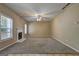 Bright living room with carpet flooring and a white mantel fireplace at 2093 Parador Bnd, Mcdonough, GA 30253