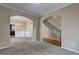 Living room with archways, leading to the dining room and stairwell at 2093 Parador Bnd, Mcdonough, GA 30253