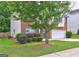 Side exterior shot with brick, vinyl siding, landscaping, and large tree at 2093 Parador Bnd, Mcdonough, GA 30253