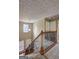 Stairway featuring carpeted treads and oak handrail with wrought iron spindles at 2093 Parador Bnd, Mcdonough, GA 30253