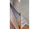 Carpeted stairway with stained oak handrail and black iron spindles at 2093 Parador Bnd, Mcdonough, GA 30253