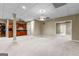 Finished basement with a bar, carpet, drop ceiling, and ample open space at 285 Spear Rd, Peachtree City, GA 30269