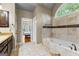 Luxurious bathroom with a soaking tub, neutral tile, and a bright, open design at 285 Spear Rd, Peachtree City, GA 30269