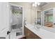 Bathroom featuring a tiled vanity, mirror, a shower and tiled floors at 285 Spear Rd, Peachtree City, GA 30269