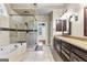 This bathroom features a soaking tub, glass shower, and a dual sink vanity at 285 Spear Rd, Peachtree City, GA 30269