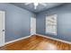 Bedroom with light blue walls, hardwood flooring, and a window at 285 Spear Rd, Peachtree City, GA 30269