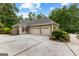Stately home with three-car garage and beautiful landscaping, showcasing curb appeal at 285 Spear Rd, Peachtree City, GA 30269