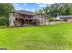 Exterior view showcasing a spacious home with an expansive deck overlooking the manicured lawn at 285 Spear Rd, Peachtree City, GA 30269