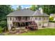 Expansive two-story home with dual decks, landscaped garden, and lush green lawn, a perfect outdoor haven at 285 Spear Rd, Peachtree City, GA 30269