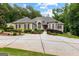 Beautifully landscaped home with a circular driveway and manicured lawn at 285 Spear Rd, Peachtree City, GA 30269