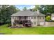 Expansive two-story home with dual decks, landscaped garden, and lush green lawn, a perfect outdoor haven at 285 Spear Rd, Peachtree City, GA 30269