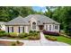 Inviting traditional home boasting a manicured lawn, beautiful landscaping, and a welcoming facade with arched windows at 285 Spear Rd, Peachtree City, GA 30269