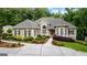 Charming home featuring manicured landscaping, a welcoming walkway, and elegant architectural details at 285 Spear Rd, Peachtree City, GA 30269