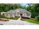 Inviting traditional home boasting a manicured lawn, beautiful landscaping, and a welcoming facade with arched windows at 285 Spear Rd, Peachtree City, GA 30269