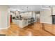 Open kitchen design with black countertops, an island with seating and stainless appliances at 285 Spear Rd, Peachtree City, GA 30269