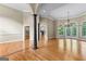Spacious living room featuring hardwood floors, elegant columns, and an abundance of natural light at 285 Spear Rd, Peachtree City, GA 30269