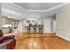 Open concept living area with hardwood floors, a fireplace, and a kitchen featuring a breakfast bar at 285 Spear Rd, Peachtree City, GA 30269