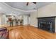 Large living area with hardwood floors, a fireplace, and a view into the open concept kitchen with breakfast bar at 285 Spear Rd, Peachtree City, GA 30269