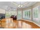 Open-concept living area with hardwood floors, plantation shutters, and a cozy fireplace at 285 Spear Rd, Peachtree City, GA 30269