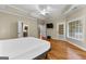 This bedroom features hardwood floors, a ceiling fan, natural light, and white trim at 285 Spear Rd, Peachtree City, GA 30269