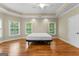 Bright and spacious main bedroom with hardwood flooring, tray ceiling, and multiple windows at 285 Spear Rd, Peachtree City, GA 30269