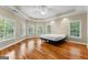 Spacious main bedroom features wood floors, tray ceilings, ceiling fan, and large windows at 285 Spear Rd, Peachtree City, GA 30269