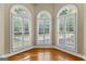 Charming sunroom with plantation shutters and arched windows offering serene views at 285 Spear Rd, Peachtree City, GA 30269