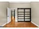 Versatile room with hardwood floors, an open doorway, and a custom built-in bookcase at 285 Spear Rd, Peachtree City, GA 30269