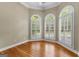 Bright, airy room with hardwood floors and arched windows, showcasing natural light at 285 Spear Rd, Peachtree City, GA 30269