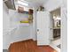 This walk-in closet features wood floors, white shelves and hanging rods at 285 Spear Rd, Peachtree City, GA 30269
