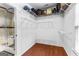 This walk-in closet features wood floors and white shelves at 285 Spear Rd, Peachtree City, GA 30269