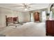 Spacious carpeted bedroom featuring neutral walls, a ceiling fan, and natural light from two windows at 550 Hawthorne Dr, Fayetteville, GA 30214