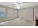 Neutral bedroom features two windows, carpet flooring, a ceiling fan and bright natural light at 550 Hawthorne Dr, Fayetteville, GA 30214