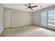 Spacious bedroom with carpet, ceiling fan, and large windows with natural light at 550 Hawthorne Dr, Fayetteville, GA 30214