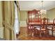 Traditional dining room featuring a chandelier, striped wallpaper, and hardwood floors at 550 Hawthorne Dr, Fayetteville, GA 30214