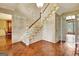 Grand foyer featuring hardwood floors, staircase, chandelier, and an open floorplan at 550 Hawthorne Dr, Fayetteville, GA 30214