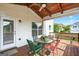 Inviting covered back porch with wood ceiling, open deck and comfortable seating area for outdoor living at 910 Pebble Creek Trl, Suwanee, GA 30024