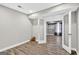 Finished basement with french doors, light gray walls and wood-look floors at 910 Pebble Creek Trl, Suwanee, GA 30024