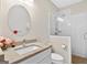 Bright bathroom featuring a modern vanity, an oval mirror, and a glass-enclosed shower with white tiling at 910 Pebble Creek Trl, Suwanee, GA 30024