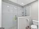 Modern bathroom featuring a glass-enclosed shower and tiled walls at 910 Pebble Creek Trl, Suwanee, GA 30024